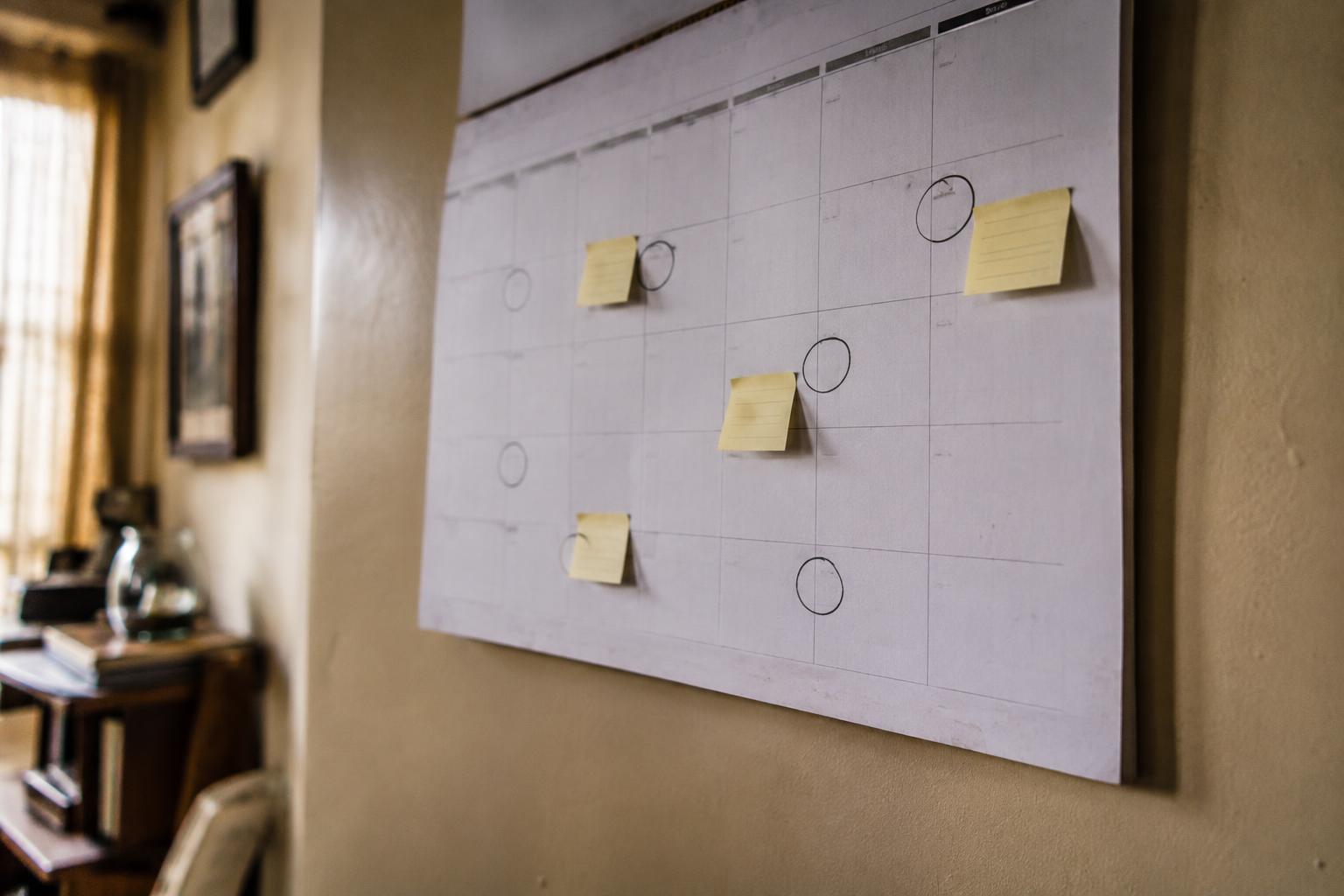 Wall calendar with circled payment dates and sticky-note reminders about annuity deadlines.